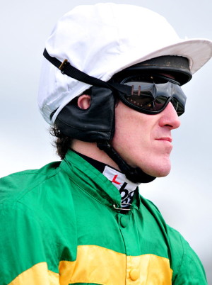 A.P McCoy in jockey silks green and yelllow