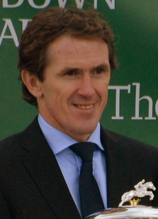 A.P McCoy wearing a suit with trophy