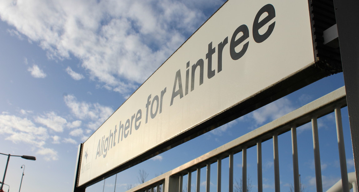 alight here for aintree sign at aintree train station